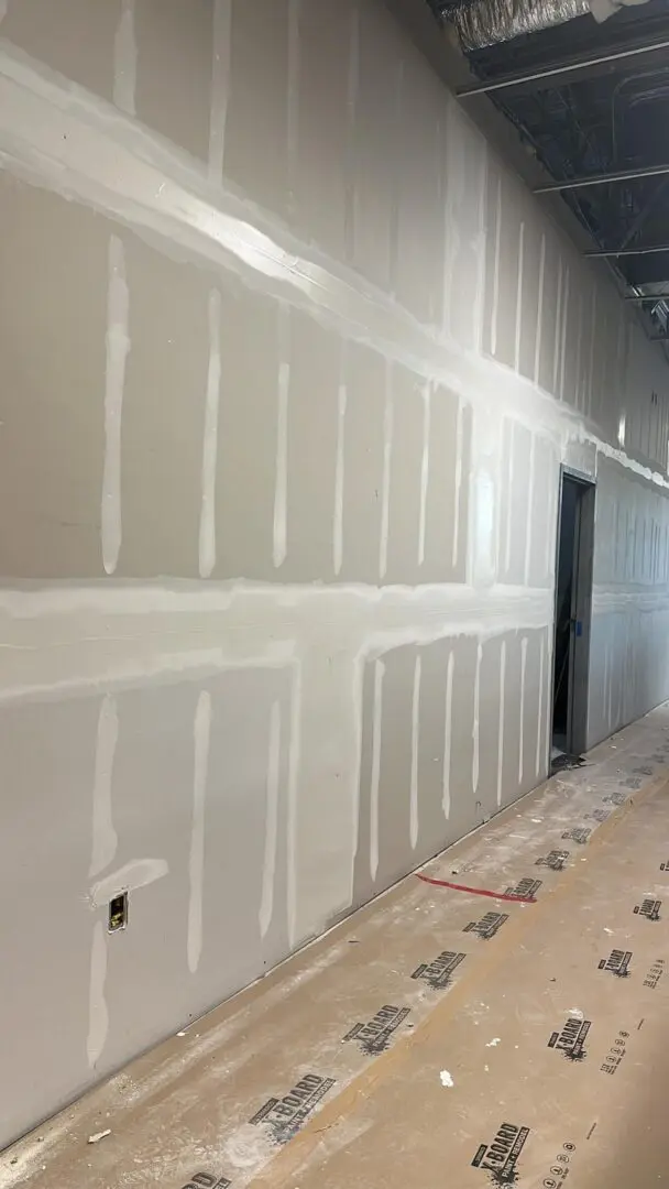 A room with walls being painted white.