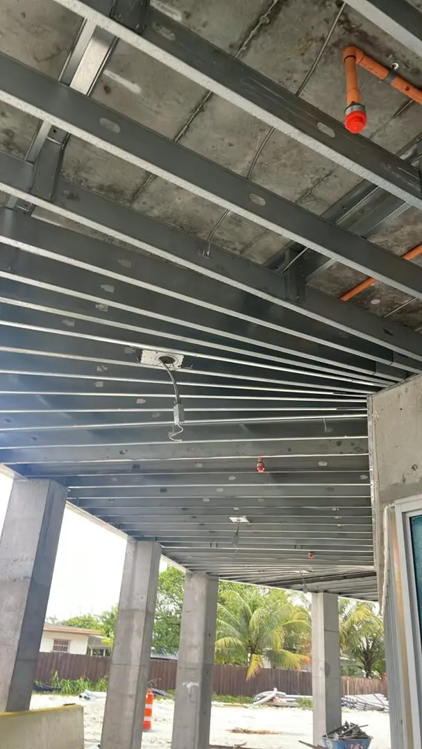 A ceiling with metal bars and beams on it.
